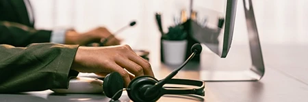 Headset and monitor on persons desk